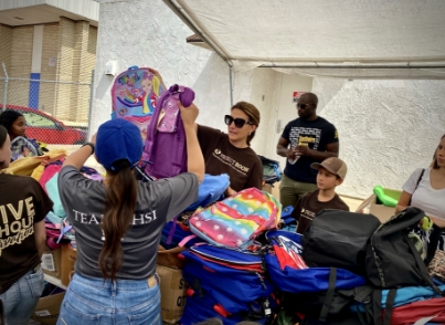 Volunteers getting ready to handout backpacks